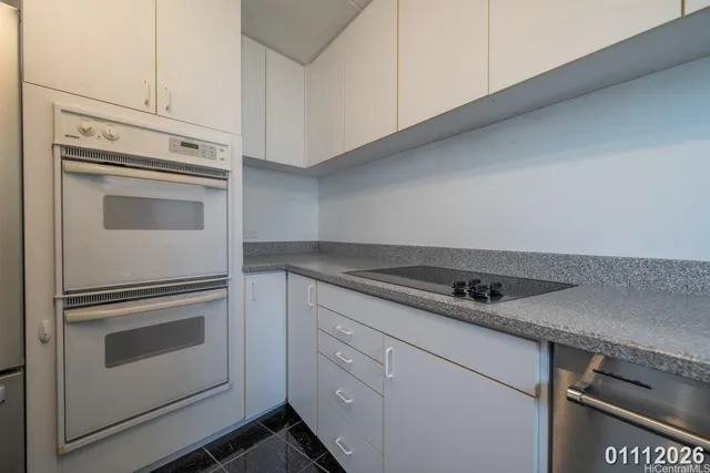a kitchen with cabinets and stainless steel appliances