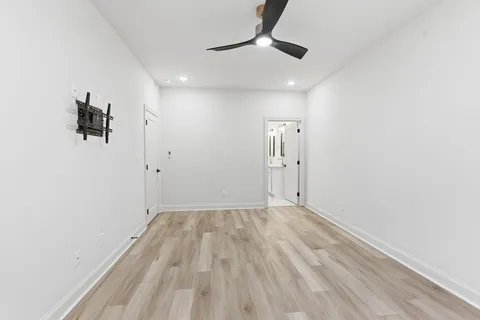 a view of an empty room with wooden floor
