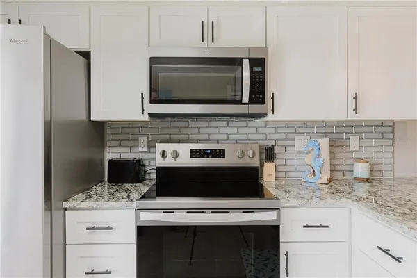 a kitchen with kitchen island granite countertop furniture and a dining table
