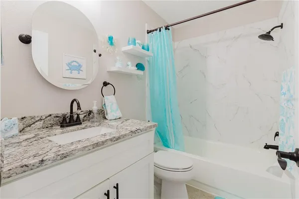 a backyard of a house with table and chairs