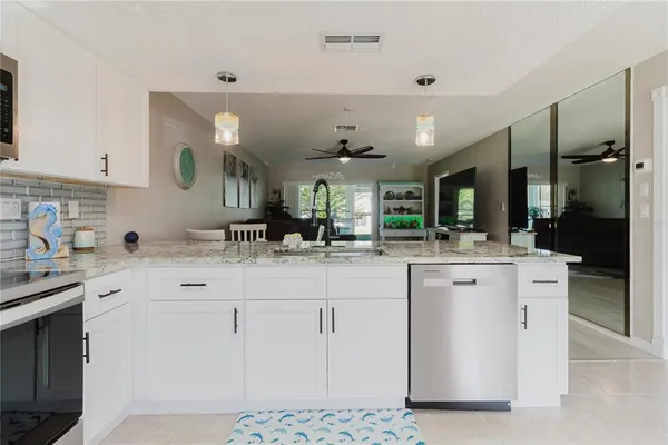 a kitchen with a sink stove and microwave