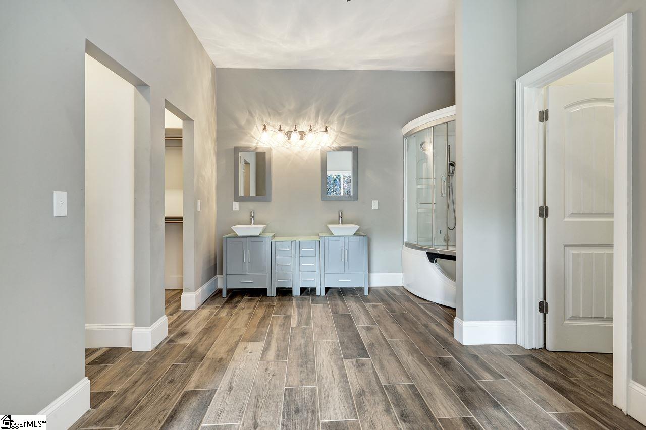 4916 State Park Road Travelers Rest, SC 29690 - Photo 17 of 34 Master bath with a double vanity, double walk in closet, private commode and Steam room shower with a bathtub included, spoil yourself in this dream steam room tub combination.