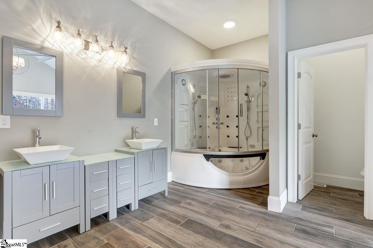 4916 State Park Road Travelers Rest, SC 29690 - Photo 18 of 34 Master bath with a double vanity, double walk in closet, private commode and Steam room shower with a bathtub included, spoil yourself in this dream steam room tub combination.