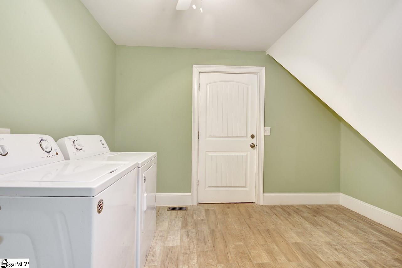 4916 State Park Road Travelers Rest, SC 29690 - Photo 33 of 34 Extra large laundry room has room for washer dryer, includes a stainless steel sink with counter, and still has plenty of room for a bench and storage, great mud room entrance from garage, with tile, to keep all the outside from getting tracked inside.