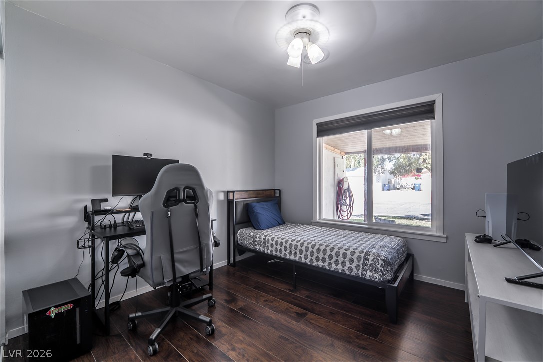 1324 Appaloosa Road Boulder City, NV 89005 - Photo 27 of 42 Rich hardwood flooring and a broad window distinguish this inviting bedroom.