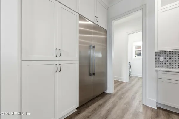 a view of walk in closet with wooden floor