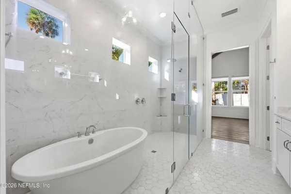 a spacious bathroom with a bathtub and shower