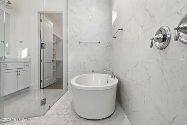 a bathroom with a sink a toilet and a shower