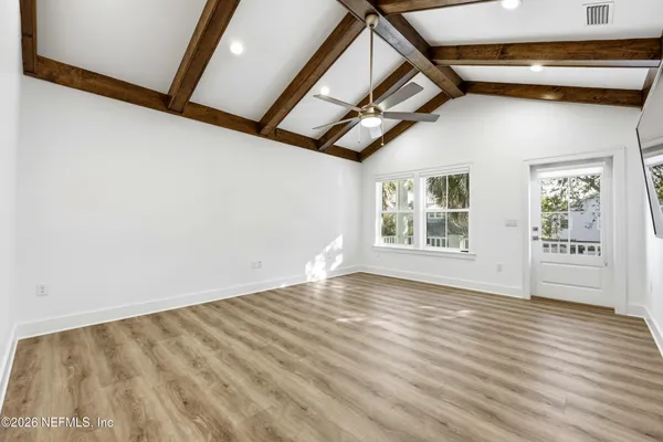 a view of an empty room with windows