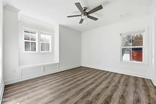 wooden floor in an empty room with a window