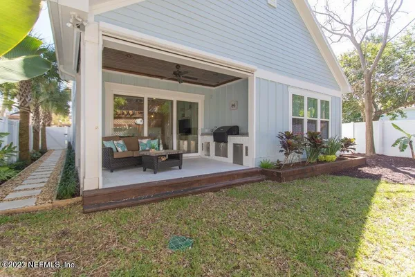 a view of a house with backyard porch and sitting area