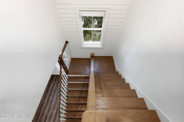 a view of entryway and hall with wooden floor
