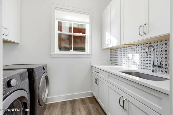 a view of a sink and washer and dryer