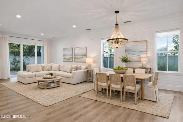 a living room with furniture chandelier and window