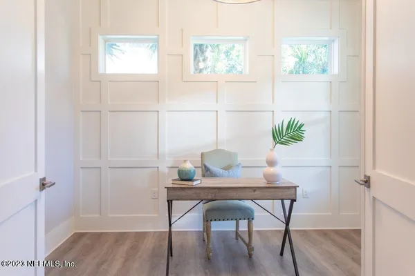 a dining room with furniture and wooden floor
