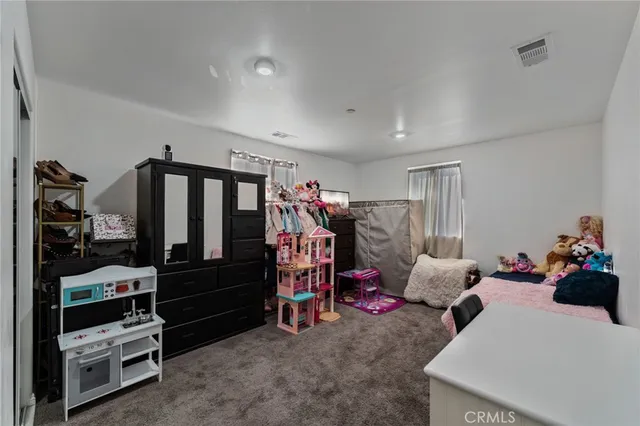 a backyard of a house with barbeque oven and outdoor seating