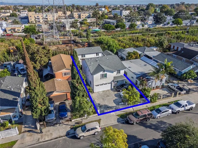 an aerial view of residential houses with outdoor space