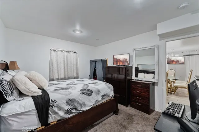 a bedroom with a bed and a mirror