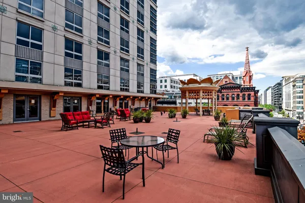 a view of a patio with dining table and chairs