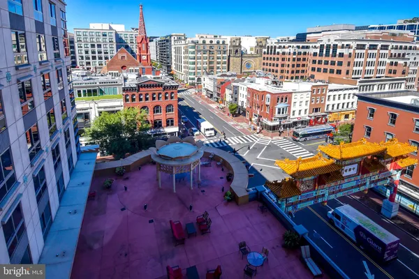 a view of a balcony with chairs and a potted plant