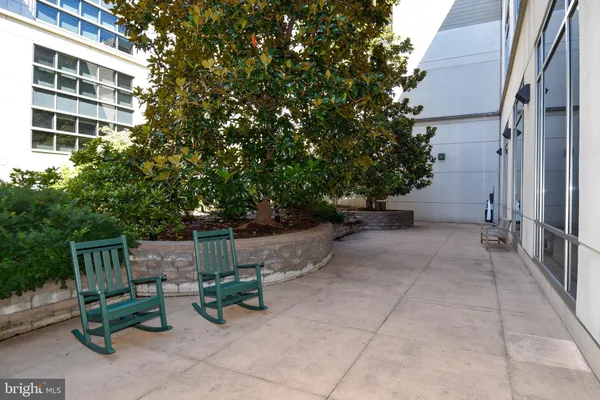 a view of backyard with outdoor seating and plants