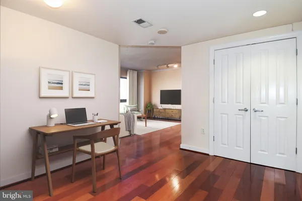 a view of a workspace with furniture and a flat screen tv