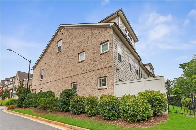 a view of a swimming pool with outdoor seating and plants