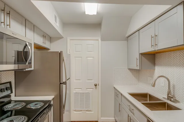 a kitchen with stainless steel appliances granite countertop a refrigerator and a sink