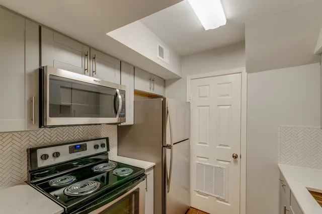 a kitchen with appliances and cabinets