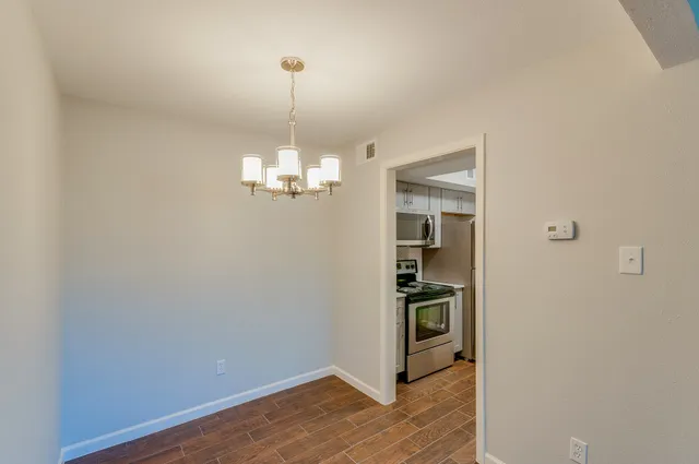 a view of a kitchen with a sink and wooden floor