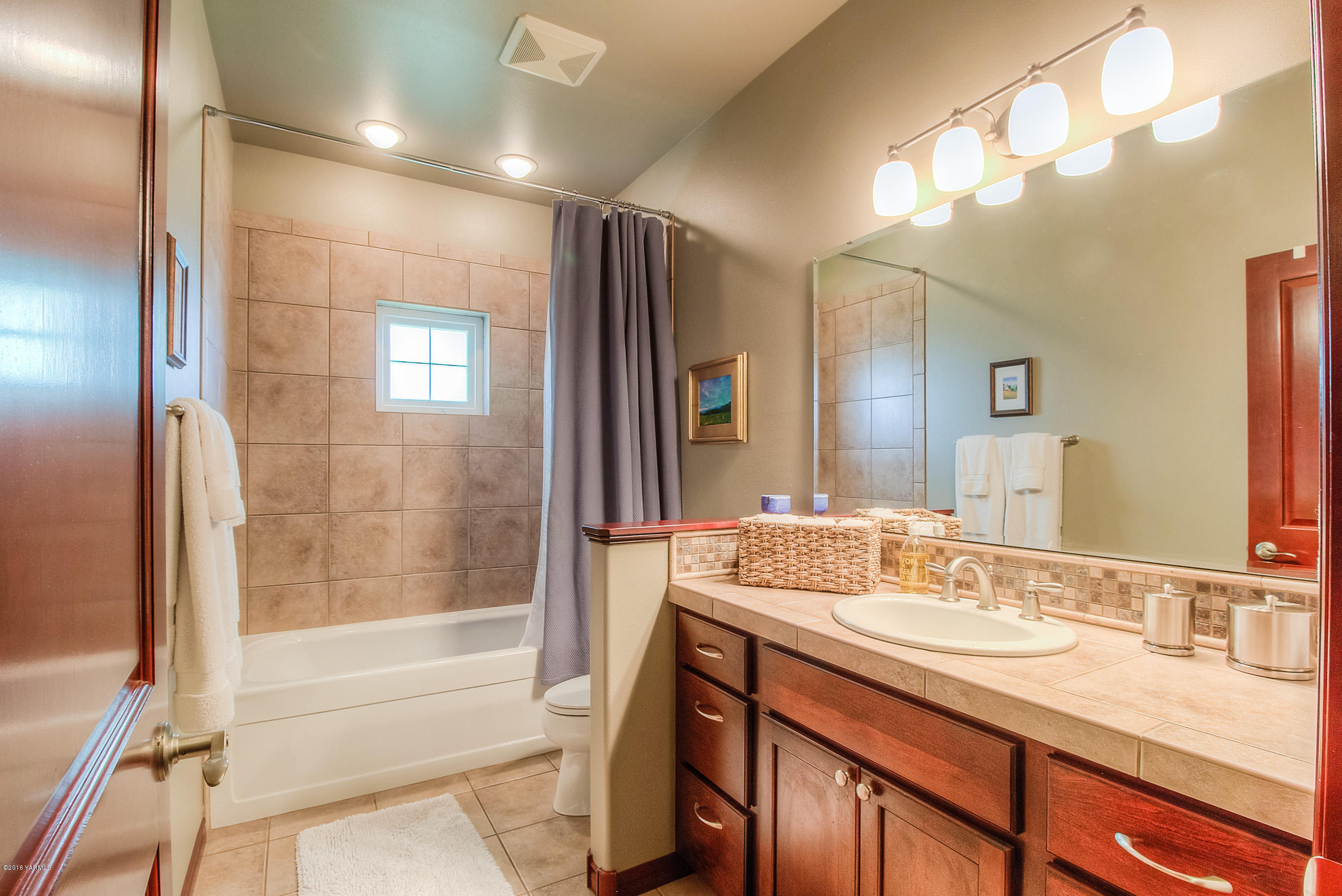 8970 Coolidge Road Yakima, WA 98903 - Photo 21 of 60 a bathroom with a granite countertop sink mirror bathtub and shower