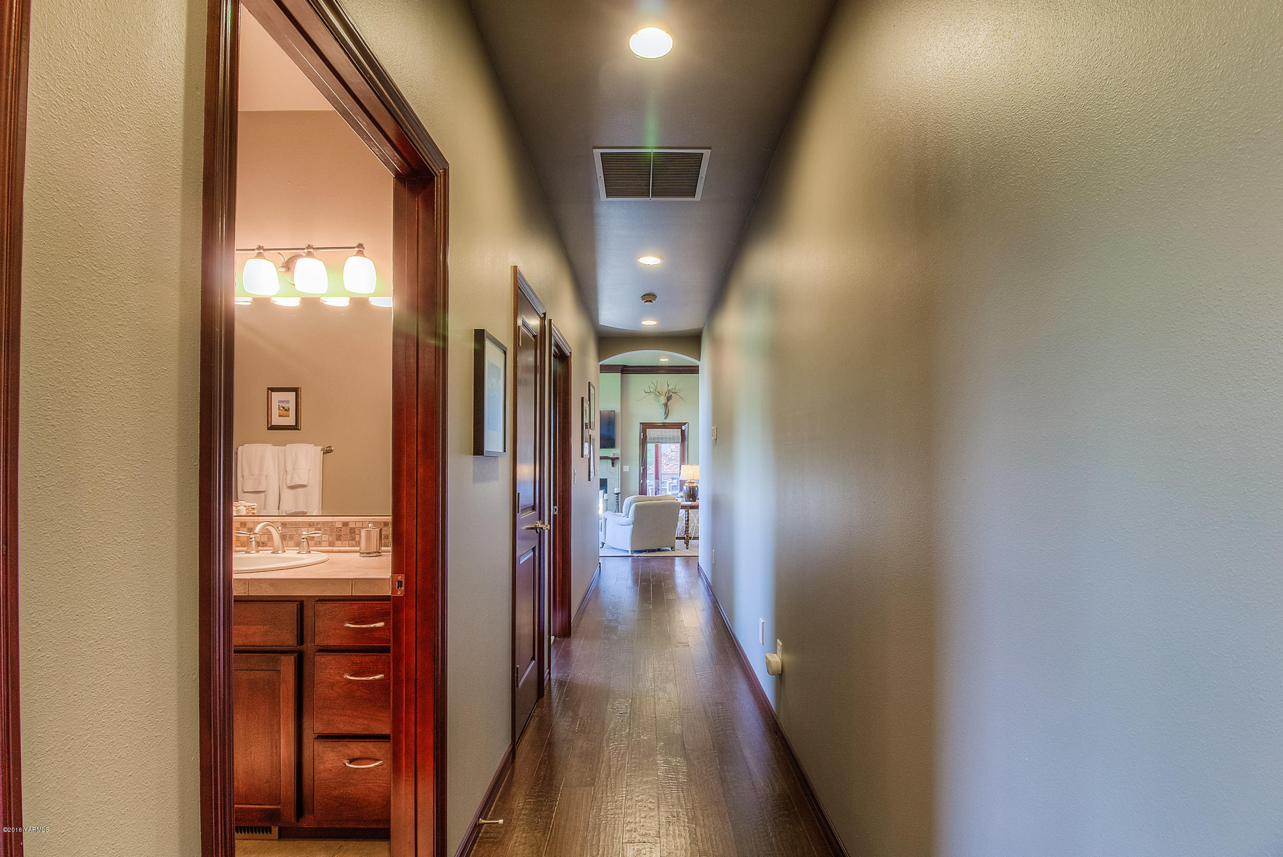 8970 Coolidge Road Yakima, WA 98903 - Photo 23 of 60 a view of hallway with stairs and wooden floor