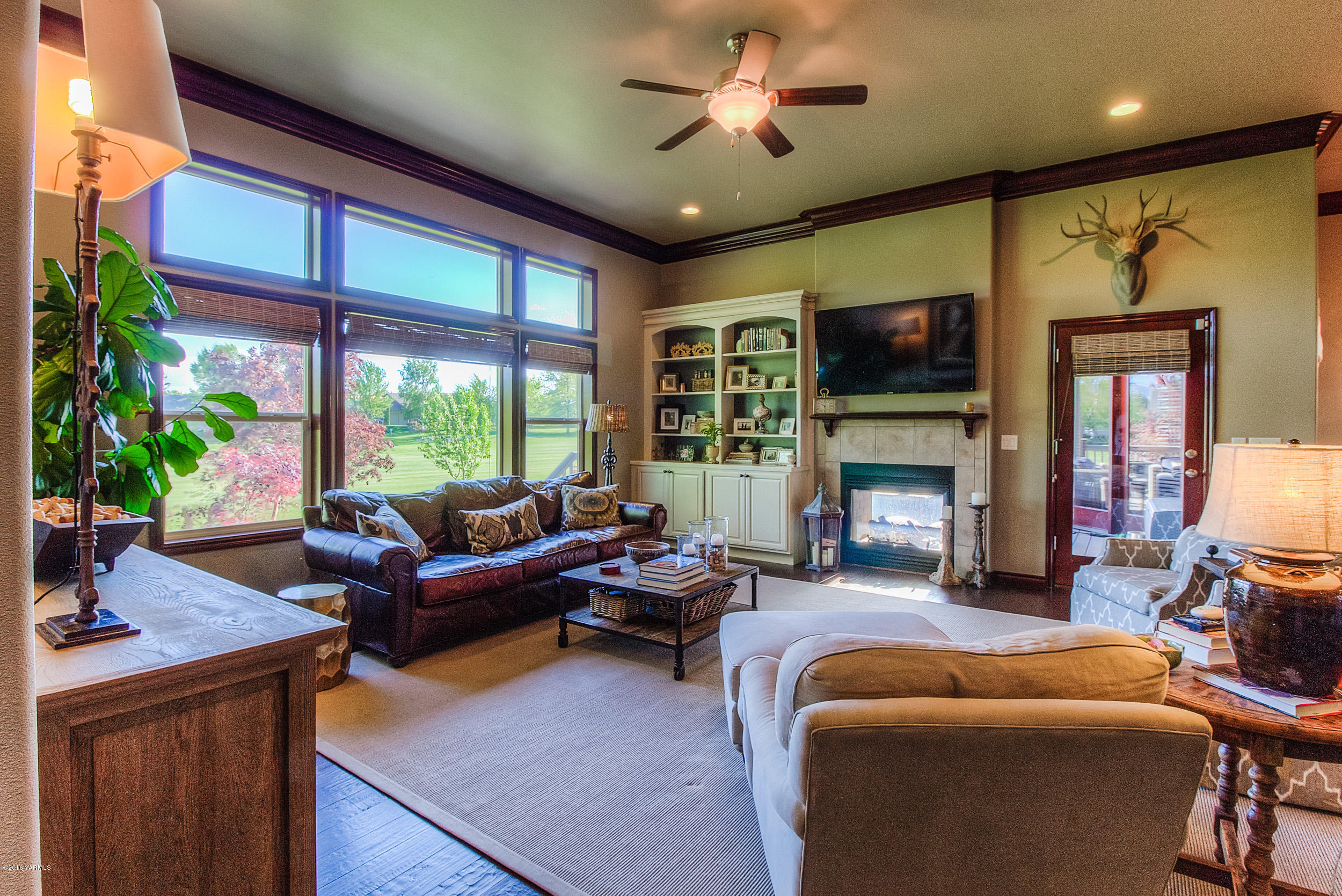 8970 Coolidge Road Yakima, WA 98903 - Photo 25 of 60 a living room with furniture a fireplace and a flat screen tv