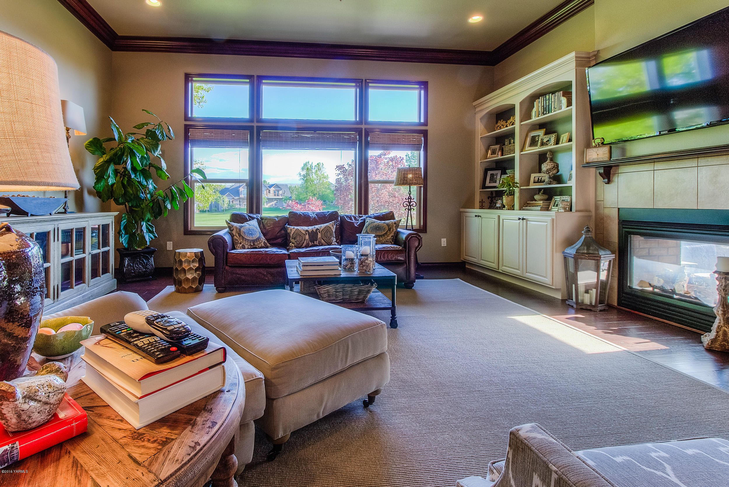8970 Coolidge Road Yakima, WA 98903 - Photo 36 of 60 a living room with furniture a flat screen tv and a fireplace