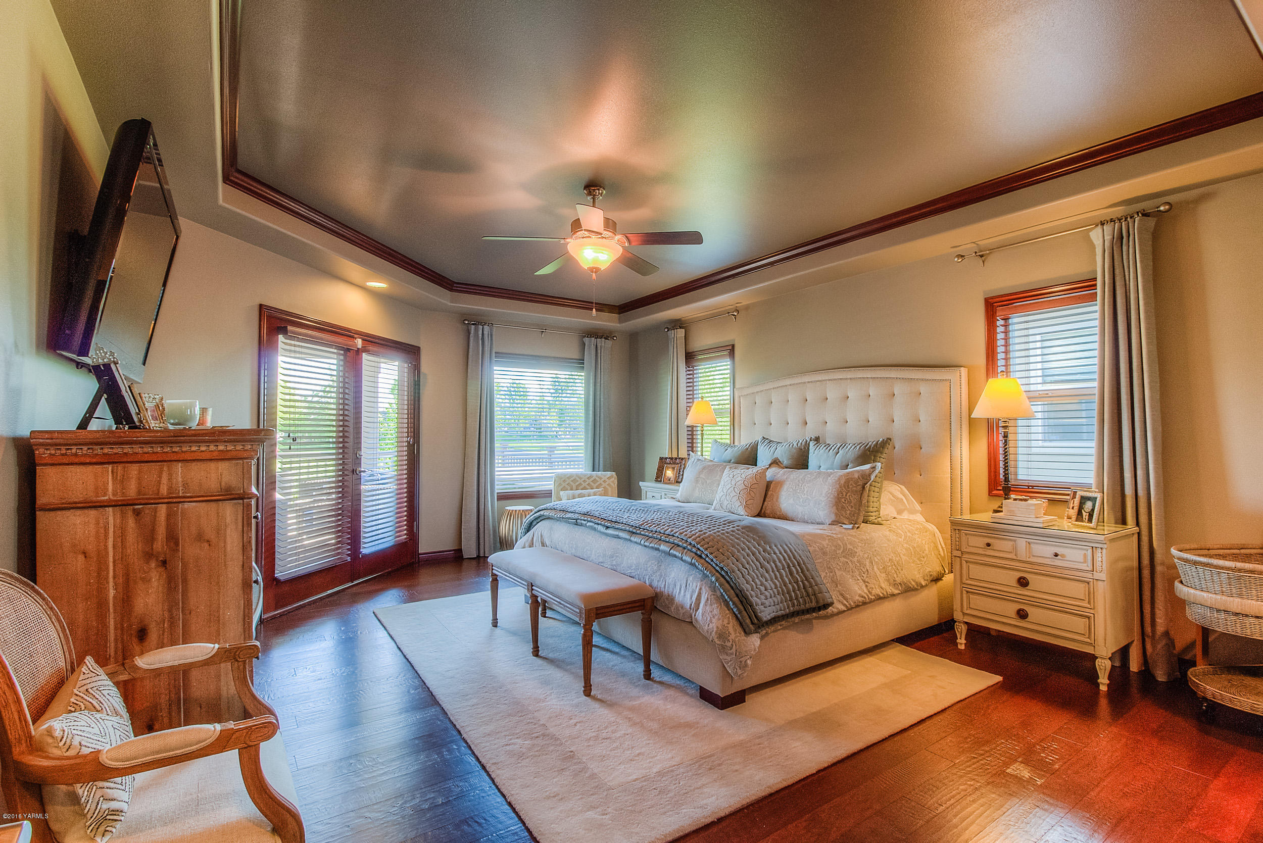 8970 Coolidge Road Yakima, WA 98903 - Photo 7 of 60 a bedroom with a bed and wooden floor