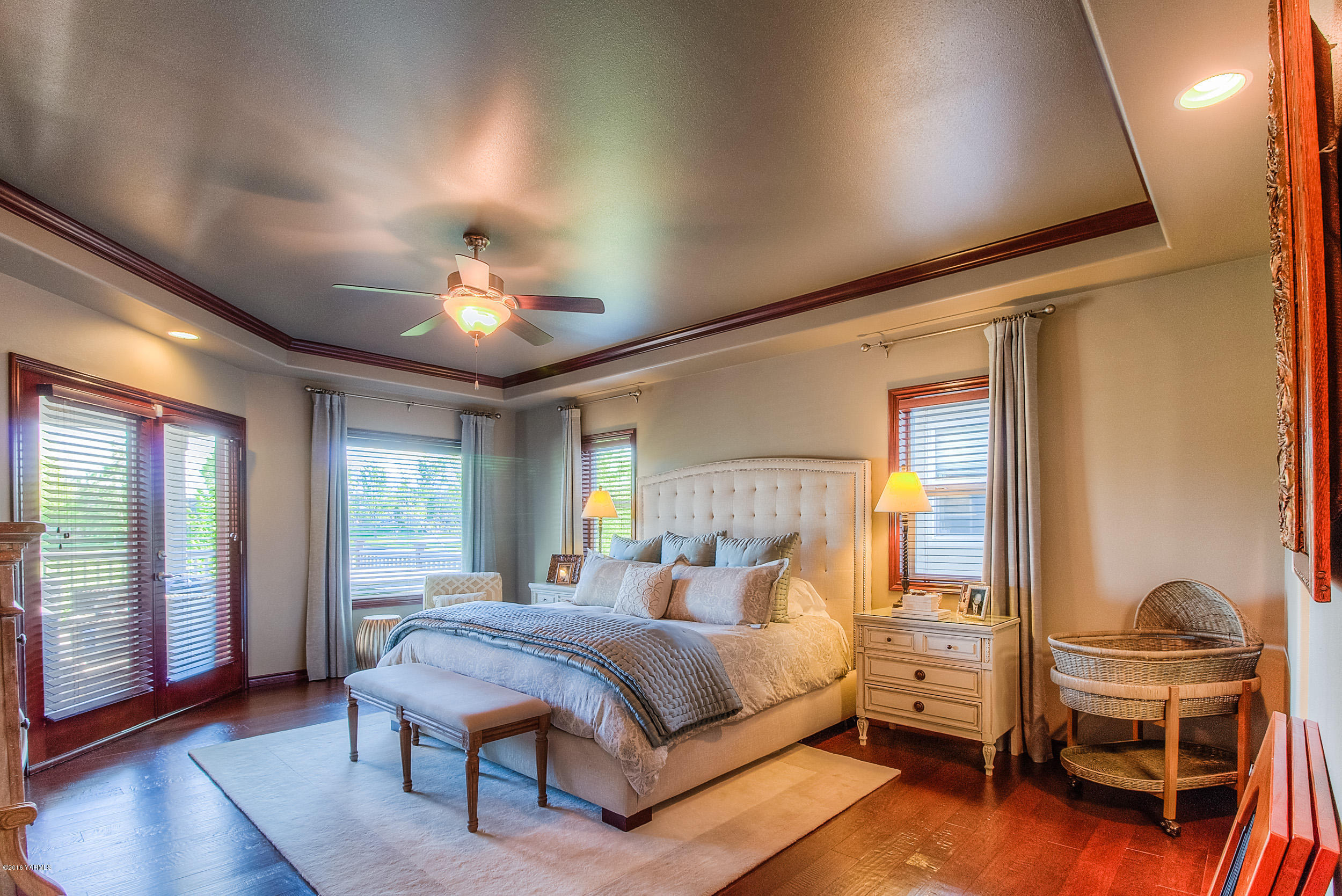 8970 Coolidge Road Yakima, WA 98903 - Photo 8 of 60 a spacious bedroom with a bed and a chandelier