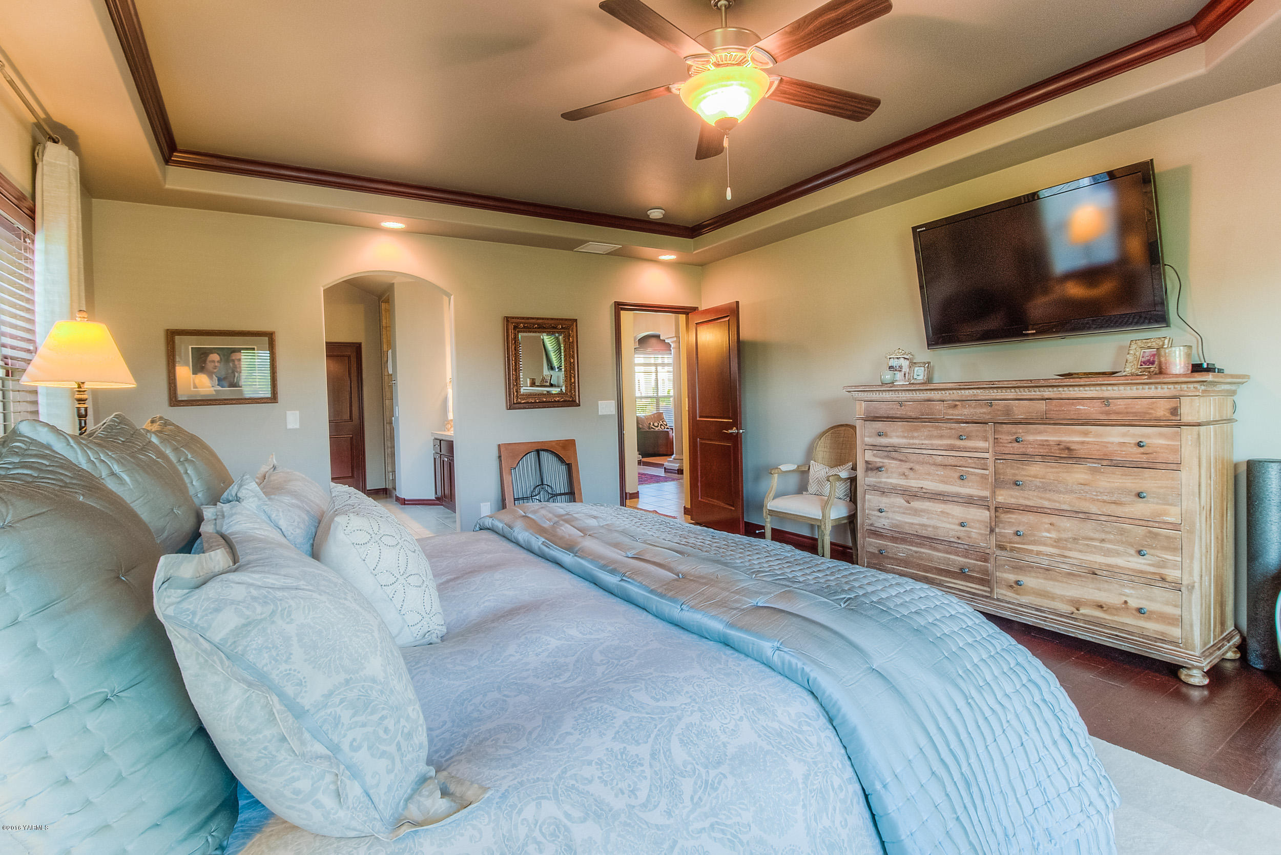 8970 Coolidge Road Yakima, WA 98903 - Photo 9 of 60 a bedroom with a bed and a flat screen tv