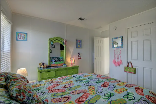 a bedroom that has a bed and a dresser in it