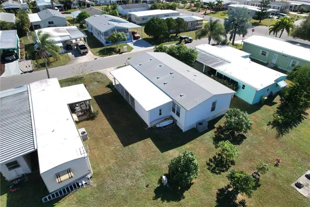an aerial view of a house with a yard