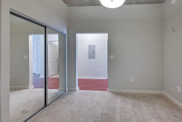 a bathroom with a granite countertop toilet a sink and a mirror