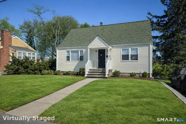a front view of a house with a garden