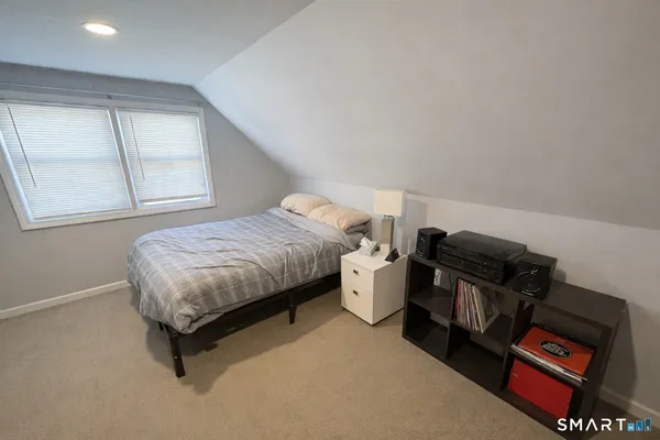 a bedroom with a bed and dresser