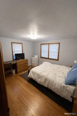 a bedroom with two beds and a window