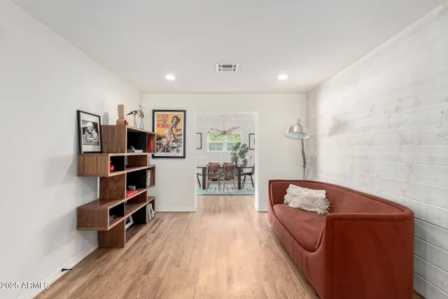 a living room with furniture and a book shelf