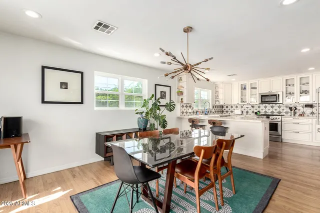a view of a dining room with furniture window and wooden floor