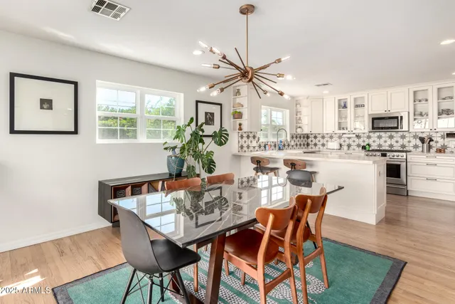 a dining room with furniture window and wooden floor