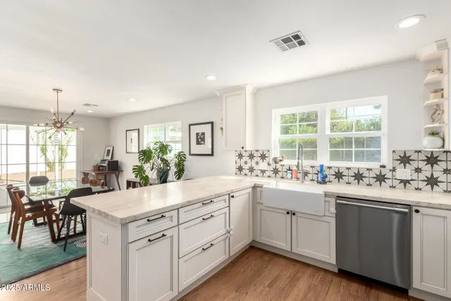a kitchen with sink cabinets and wooden floor