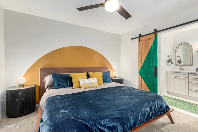 a bedroom with a bed and a chandelier