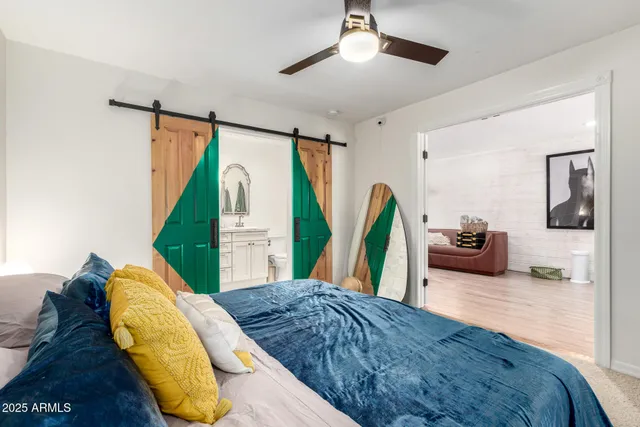 a bedroom with a bed window and a wooden floor