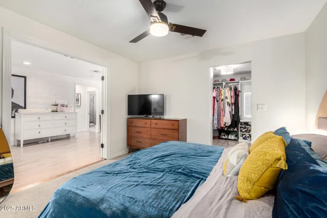 a bedroom with a bed and a flat screen tv